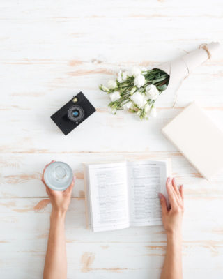 Women hands open book on the wooden desk Wooden desk